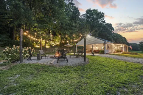 a living room with fireplace furniture and a flat screen tv