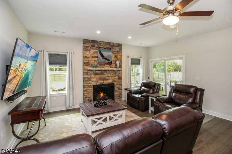 21 Harris Hawk Road Washington, NJ 07882 - Photo 12 of 26 a living room with furniture a flat screen tv and a fireplace
