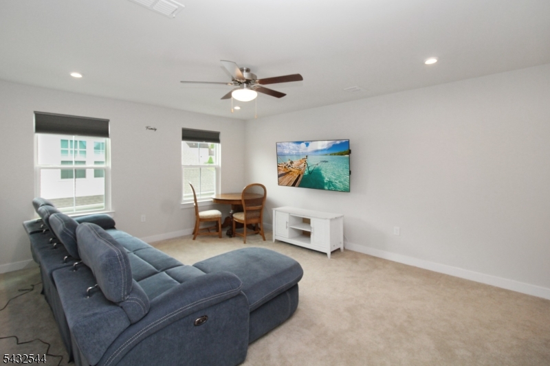 21 Harris Hawk Road Washington, NJ 07882 - Photo 18 of 26 a living room with furniture and a window