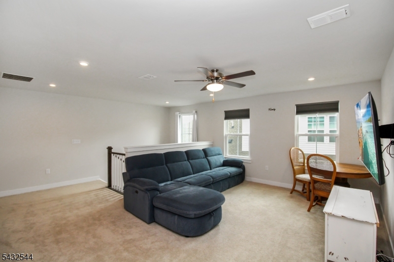 21 Harris Hawk Road Washington, NJ 07882 - Photo 19 of 26 a living room with furniture and a window