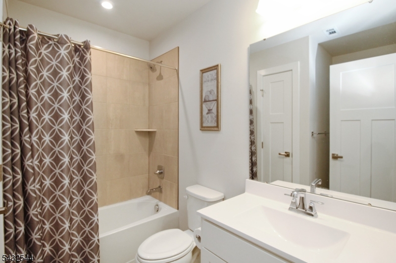21 Harris Hawk Road Washington, NJ 07882 - Photo 21 of 26 a bathroom with a sink toilet and shower