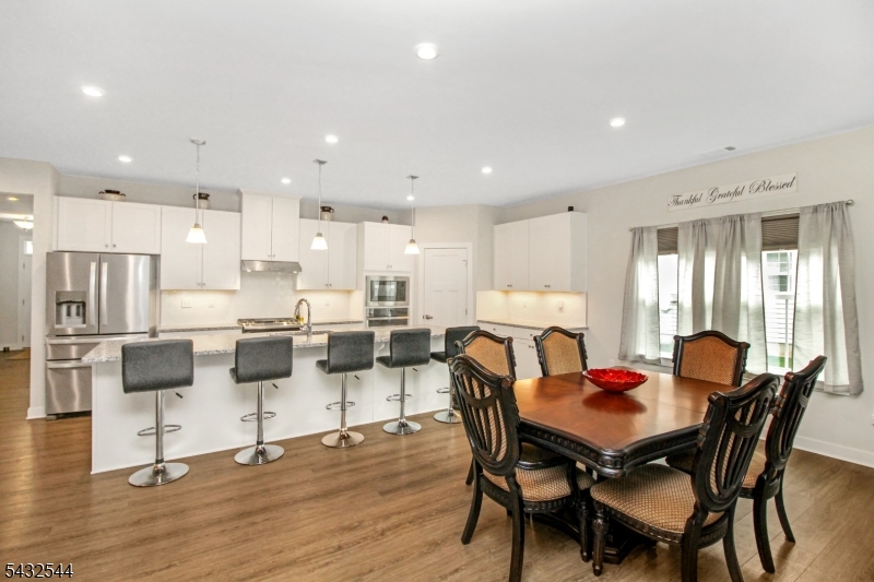 21 Harris Hawk Road Washington, NJ 07882 - Photo 8 of 26 a view of a dining room with furniture and wooden floor