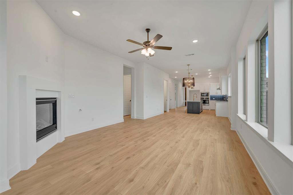 1856 Lightner Road Van Alstyne, TX 75495 - Photo 28 of 33 Expansive open-concept room featuring wood-finish flooring, a contemporary fireplace, and recessed lighting