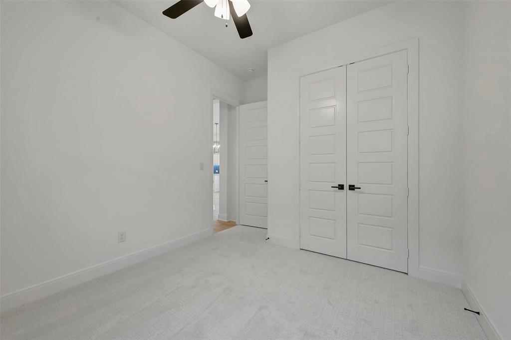 1856 Lightner Road Van Alstyne, TX 75495 - Photo 31 of 33 Bedroom featuring light-colored carpeting, white walls, and a ceiling fan with integrated lighting