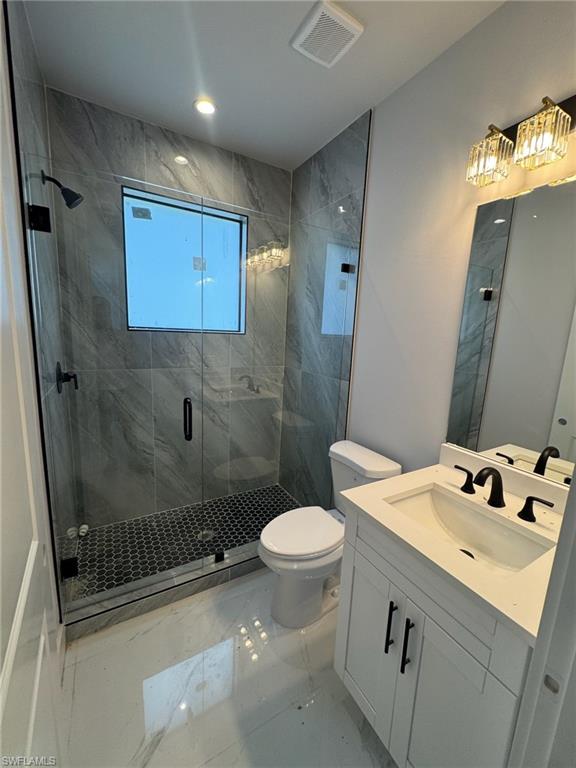 4263 18th Avenue Southeast Naples, FL 34117 - Photo 11 of 23 a bathroom with a sink toilet and shower