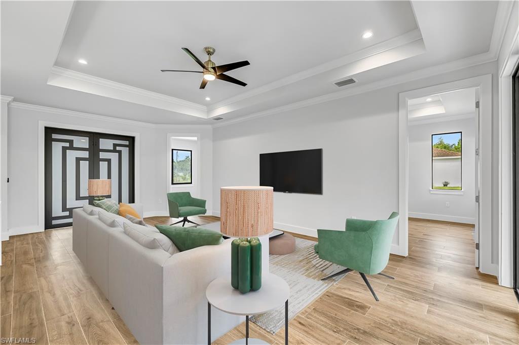 4263 18th Avenue Southeast Naples, FL 34117 - Photo 12 of 23 a living room with furniture and a flat screen tv