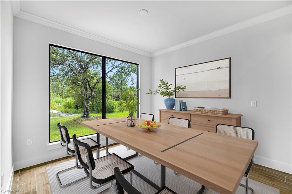 4263 18th Avenue Southeast Naples, FL 34117 - Photo 14 of 23 a view of a dining room with furniture window and wooden floor