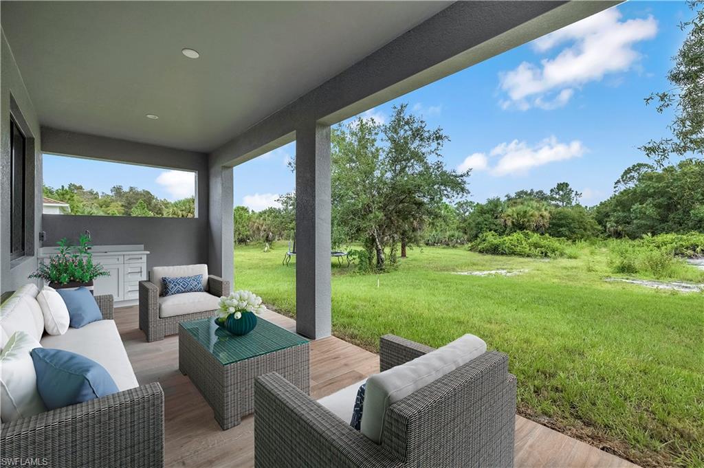 4263 18th Avenue Southeast Naples, FL 34117 - Photo 15 of 23 a outdoor living space with furniture and garden view