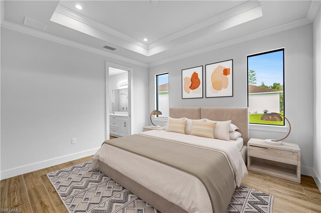 4263 18th Avenue Southeast Naples, FL 34117 - Photo 17 of 23 a bedroom with a bed and painting on the wall