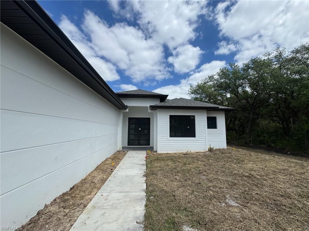 4263 18th Avenue Southeast Naples, FL 34117 - Photo 2 of 23 a house with trees in front of it