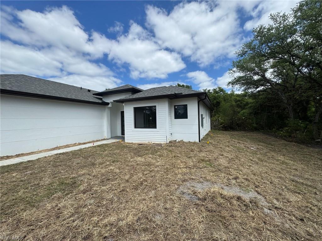 4263 18th Avenue Southeast Naples, FL 34117 - Photo 3 of 23 a backyard of a house with lots of green space