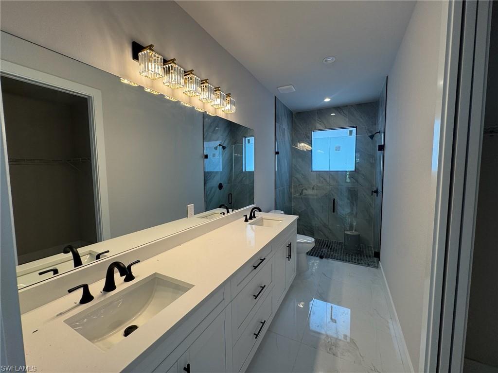 4263 18th Avenue Southeast Naples, FL 34117 - Photo 10 of 23 a bathroom with a tub sink and mirror