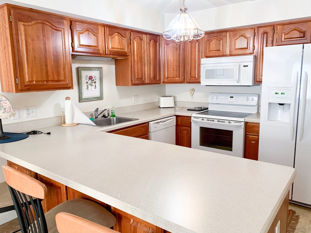 a kitchen with stainless steel appliances a stove a refrigerator a sink and dishwasher