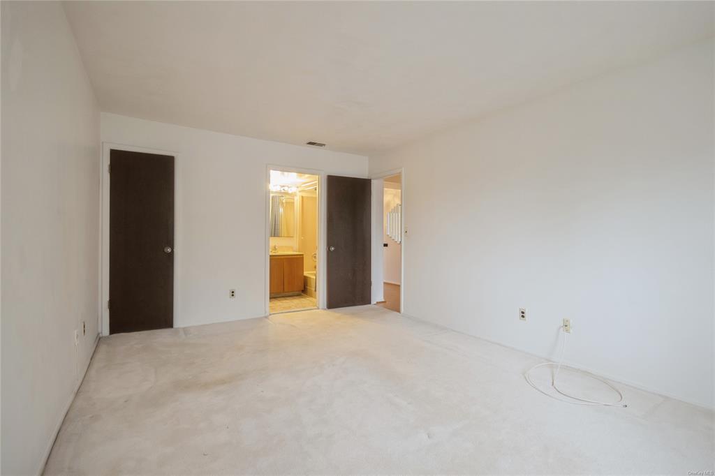 148 Flintlock Way, Unit E Yorktown Heights, NY 10598 - Photo 14 of 27 View of carpeted empty room