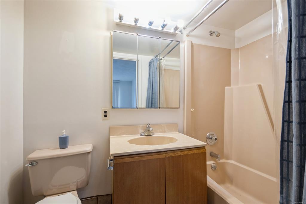 148 Flintlock Way, Unit E Yorktown Heights, NY 10598 - Photo 15 of 27 Full bathroom featuring shower / bath combo, vanity, and toilet
