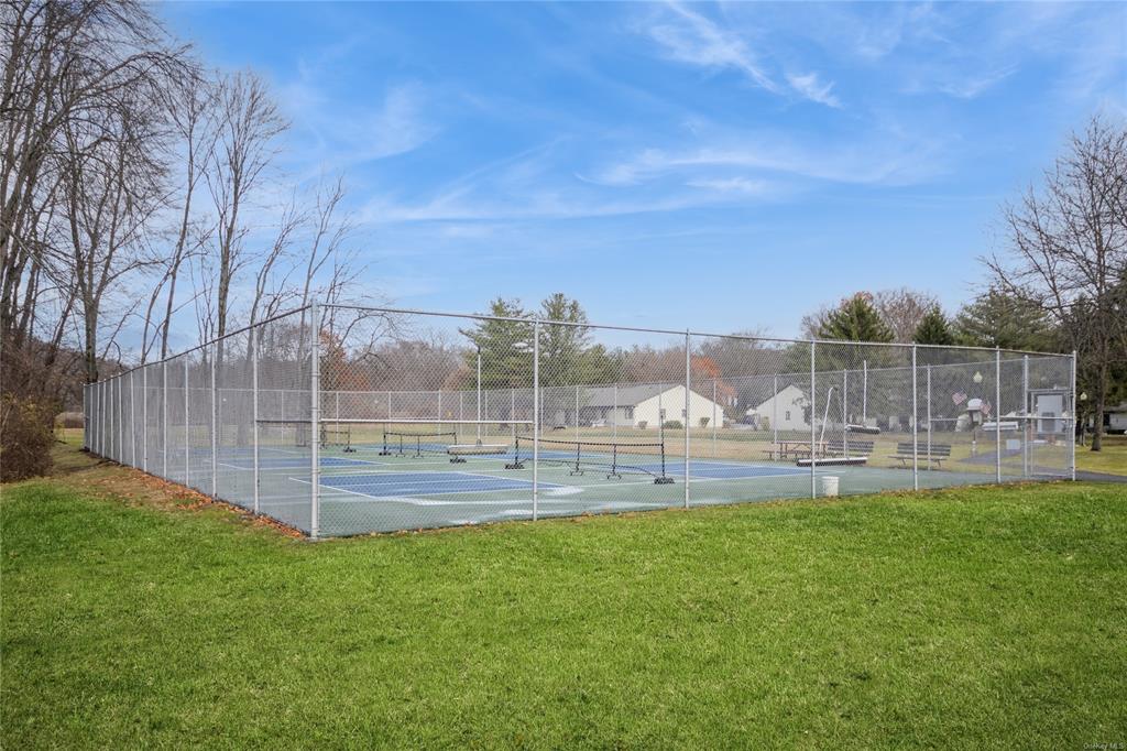 148 Flintlock Way, Unit E Yorktown Heights, NY 10598 - Photo 25 of 27 View of tennis court featuring a yard