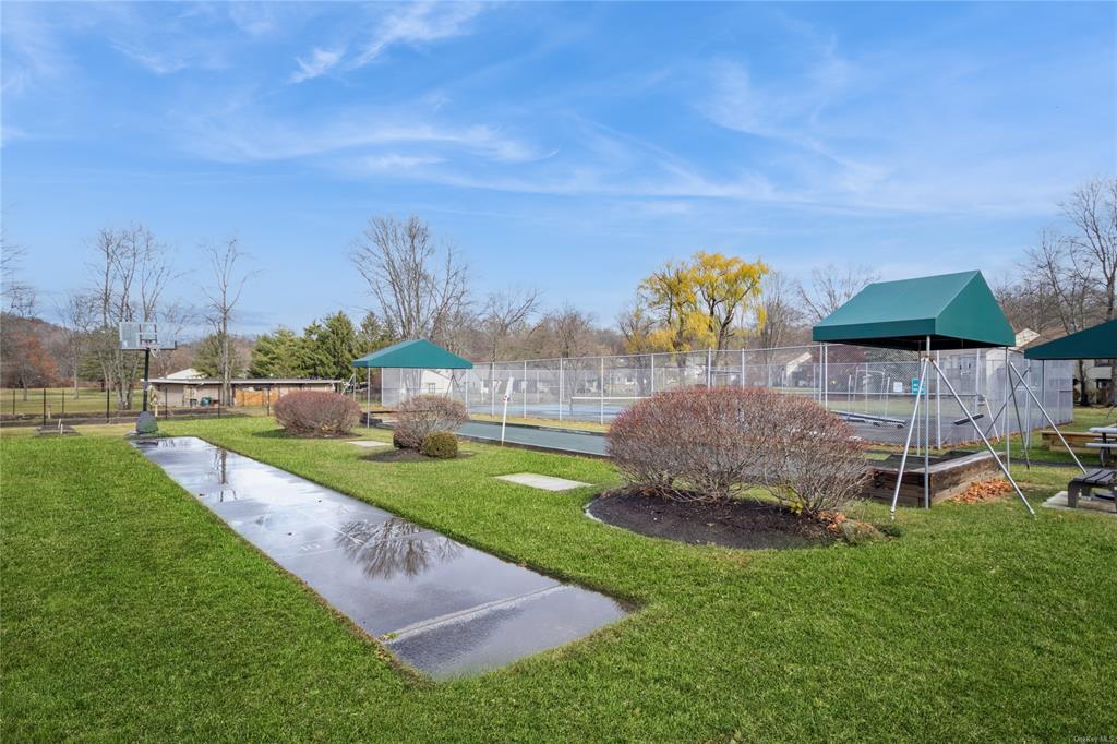 148 Flintlock Way, Unit E Yorktown Heights, NY 10598 - Photo 26 of 27 Surrounding community with a lawn and tennis court