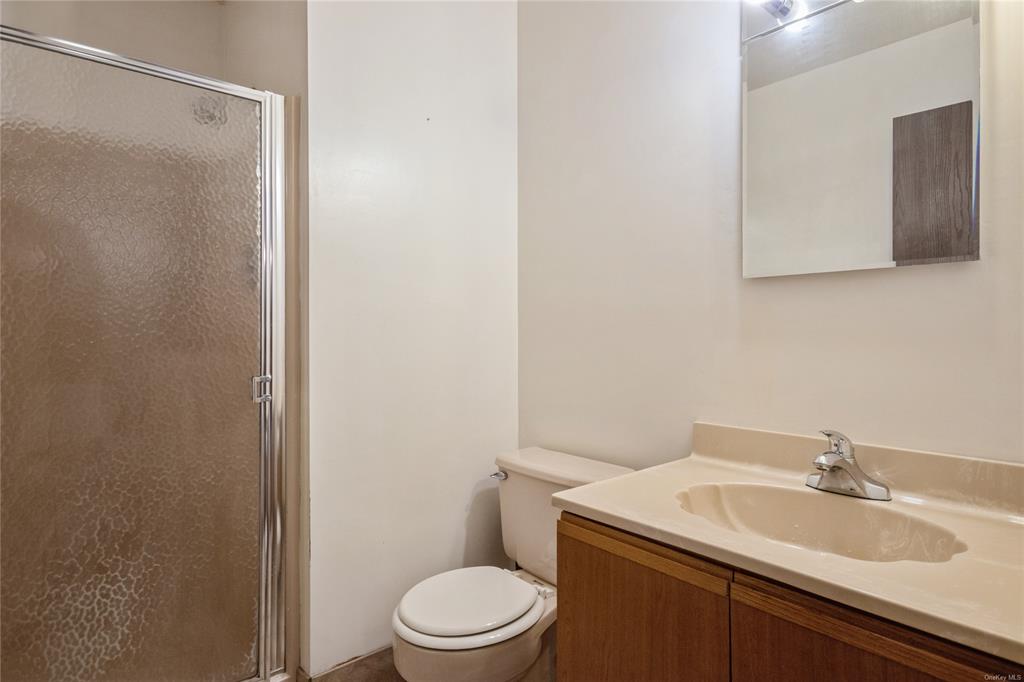 148 Flintlock Way, Unit E Yorktown Heights, NY 10598 - Photo 10 of 27 Bathroom with vanity, toilet, and an enclosed shower