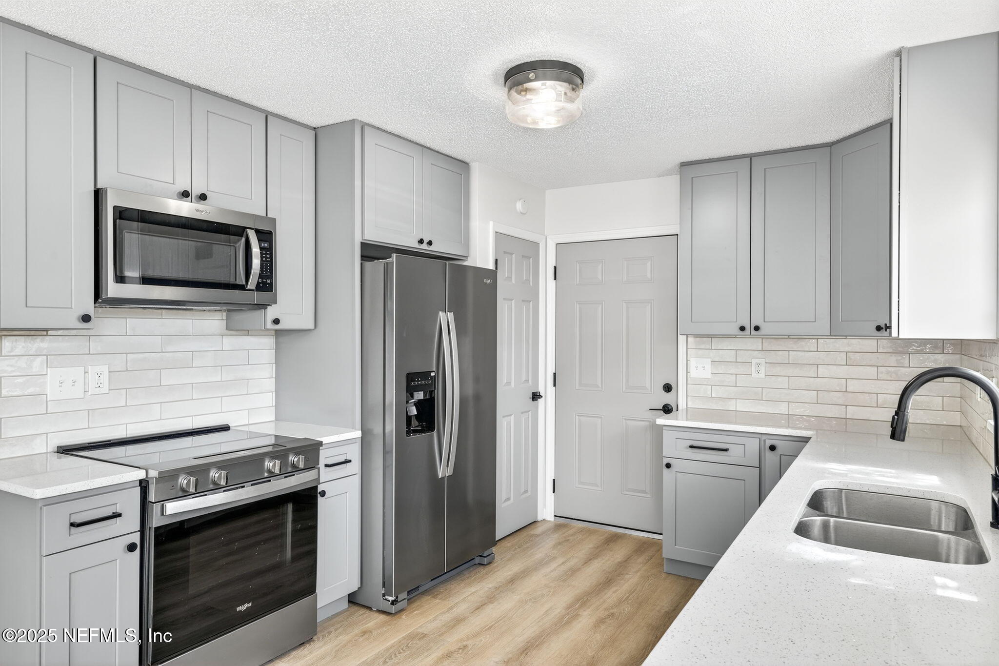 258 Wisteria Road St. Augustine, FL 32086 - Photo 11 of 33 a kitchen with stainless steel appliances a stove a sink and a refrigerator