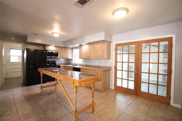 a kitchen with stainless steel appliances granite countertop a refrigerator and a sink