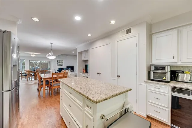 a kitchen with stainless steel appliances granite countertop refrigerator oven stove microwave and cabinets