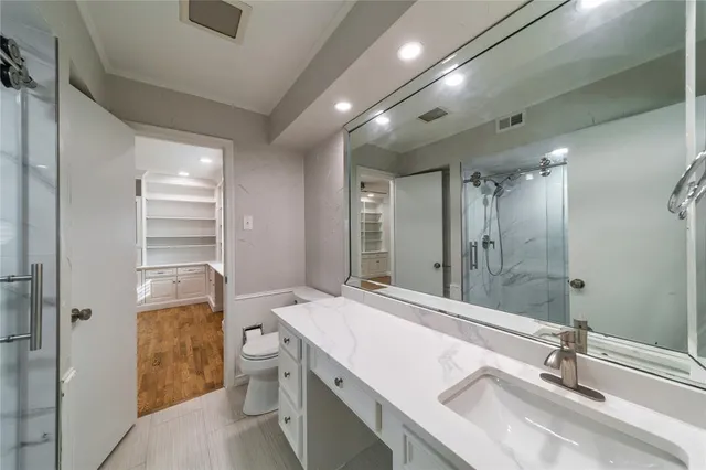 a bathroom with a sink double vanity and a shower