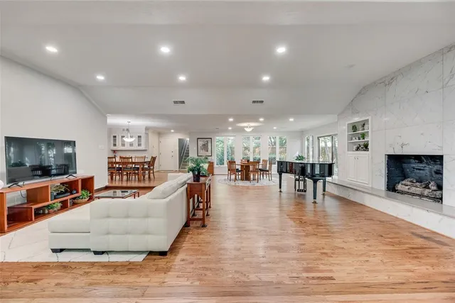 a living room with fireplace furniture and a flat screen tv