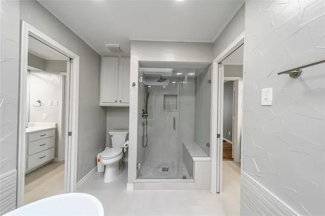 a bathroom with a granite countertop sink toilet and shower