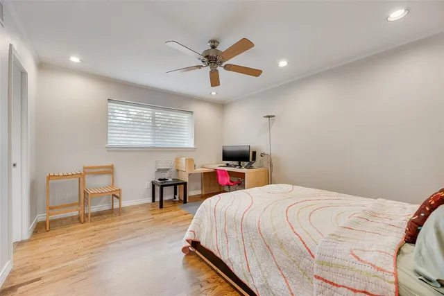 a bedroom with a bed and a desk