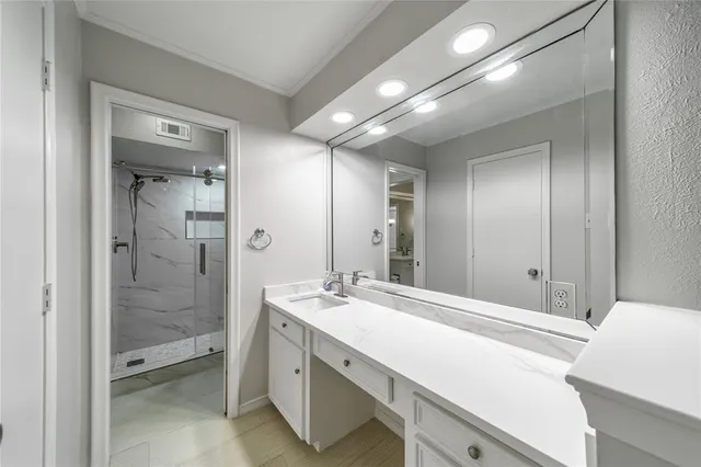 a bathroom with a shower sink and mirror
