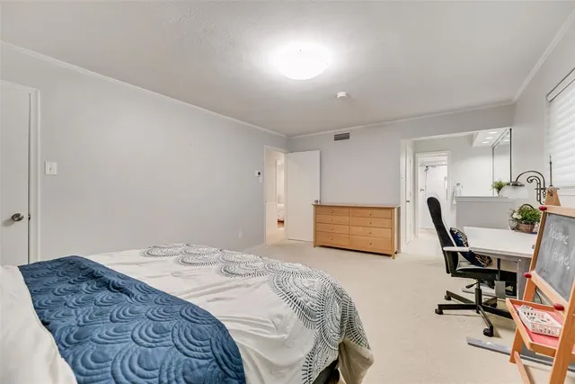 a bedroom with a bed a desk and chair