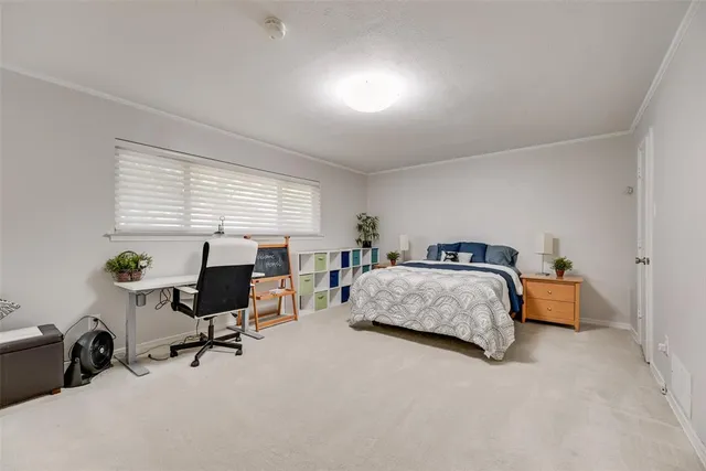 a bedroom with a bed and a desk