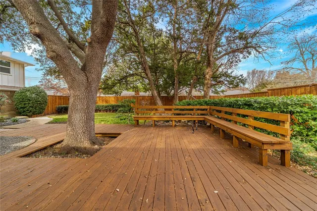 a view of a balcony with wooden floor and outdoor space
