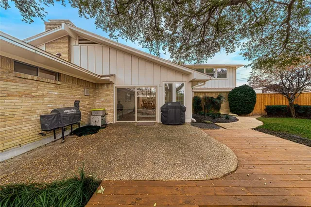 a backyard of a house with table and chairs