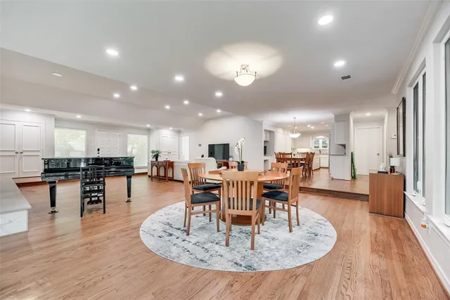 a dining room with furniture a wooden floor and a view