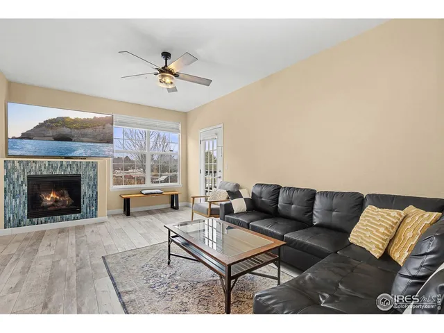 a living room with furniture a fireplace and a flat screen tv
