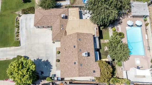 a kitchen with stainless steel appliances a stove a sink a dining table and chairs with wooden floor