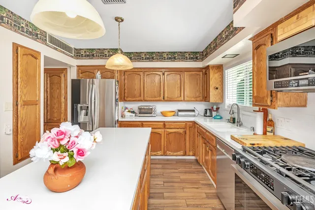 a dining room with furniture a chandelier and wooden floor