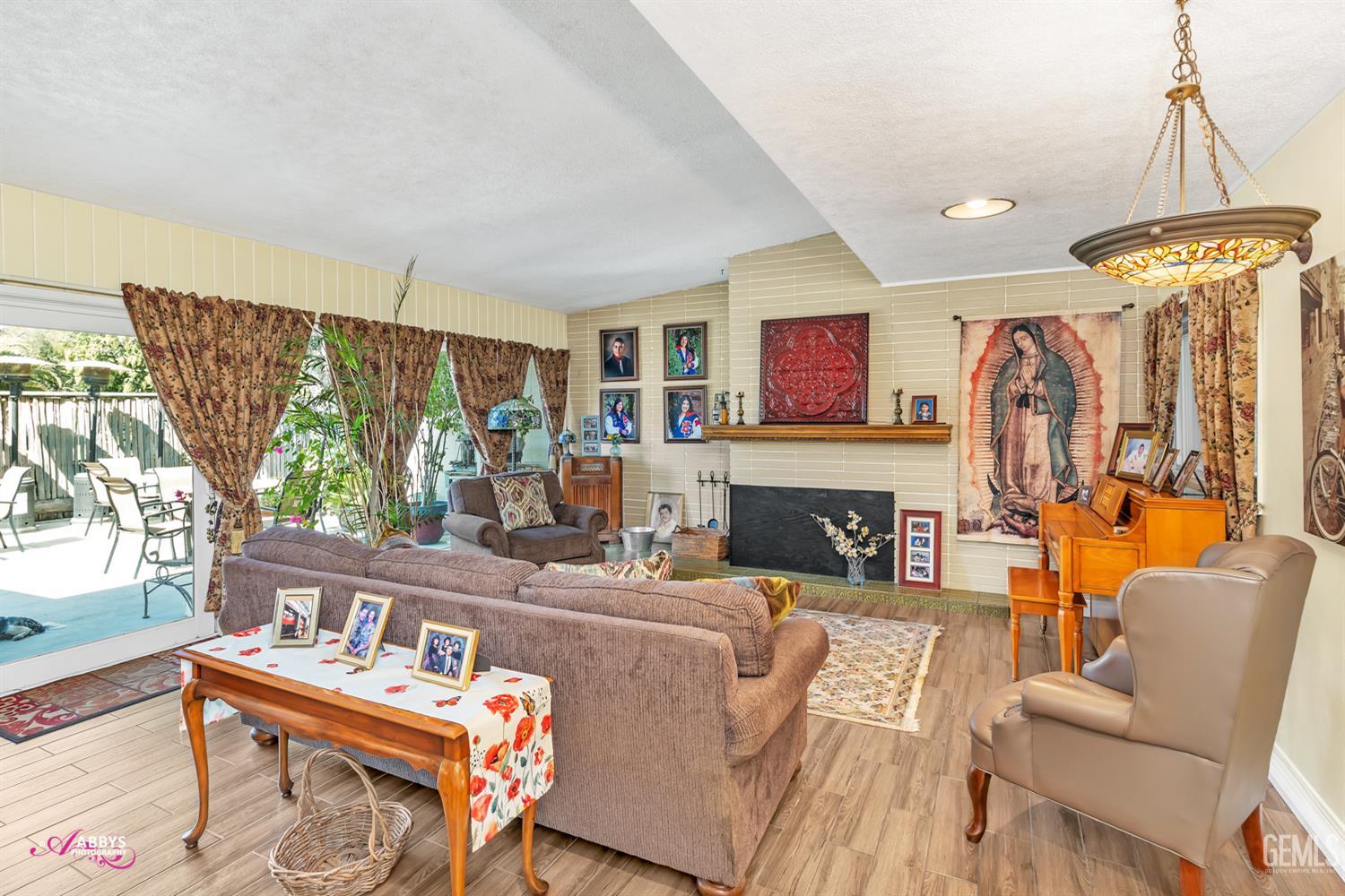 Undisclosed Address Bakersfield, CA 93306 - Photo 22 of 56 a living room with fireplace furniture and a large window