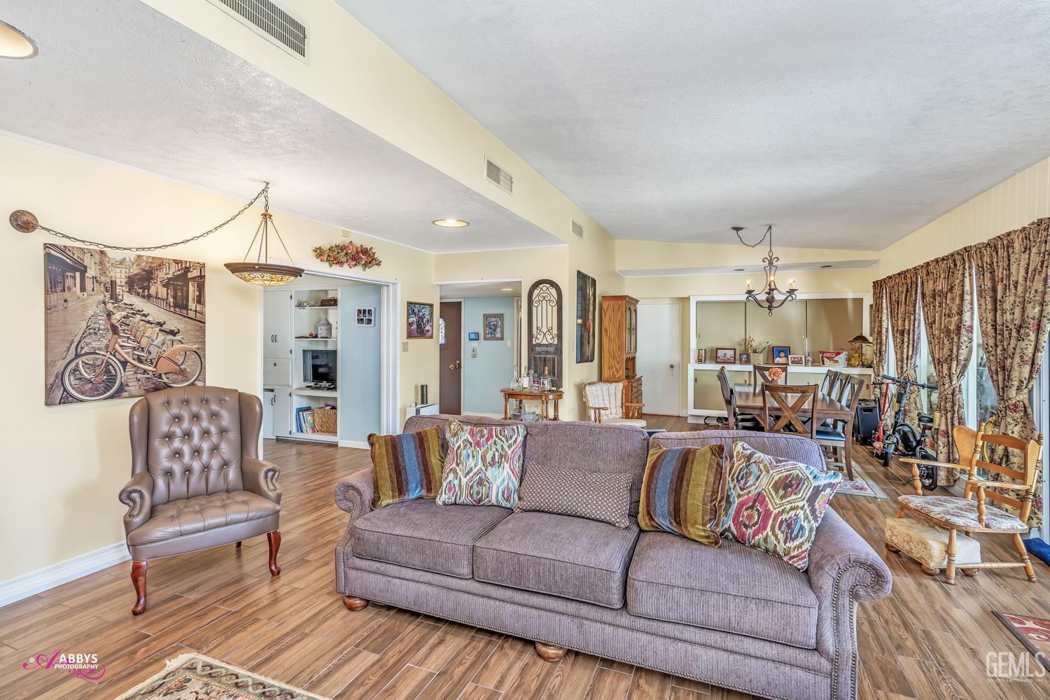 Undisclosed Address Bakersfield, CA 93306 - Photo 24 of 56 a living room with furniture kitchen view and a chandelier