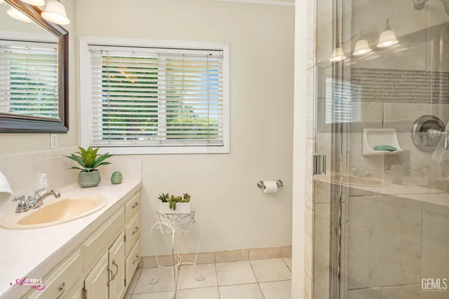 a bathroom with a bathtub a window and a shower