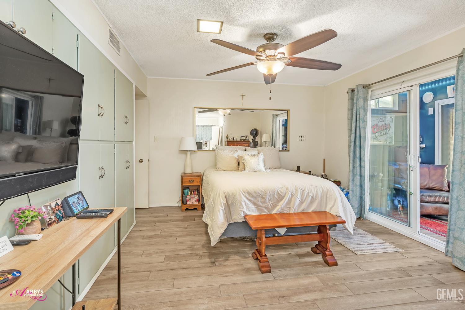 Undisclosed Address Bakersfield, CA 93306 - Photo 28 of 56 a bedroom with a bed and a chandelier