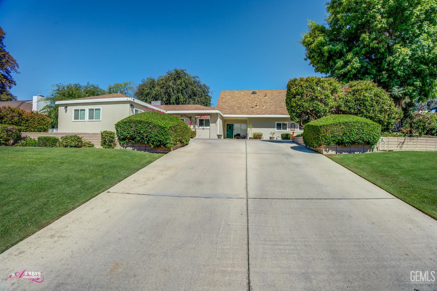 Undisclosed Address Bakersfield, CA 93306 - Photo 3 of 56 a view of a house with a yard and potted plants
