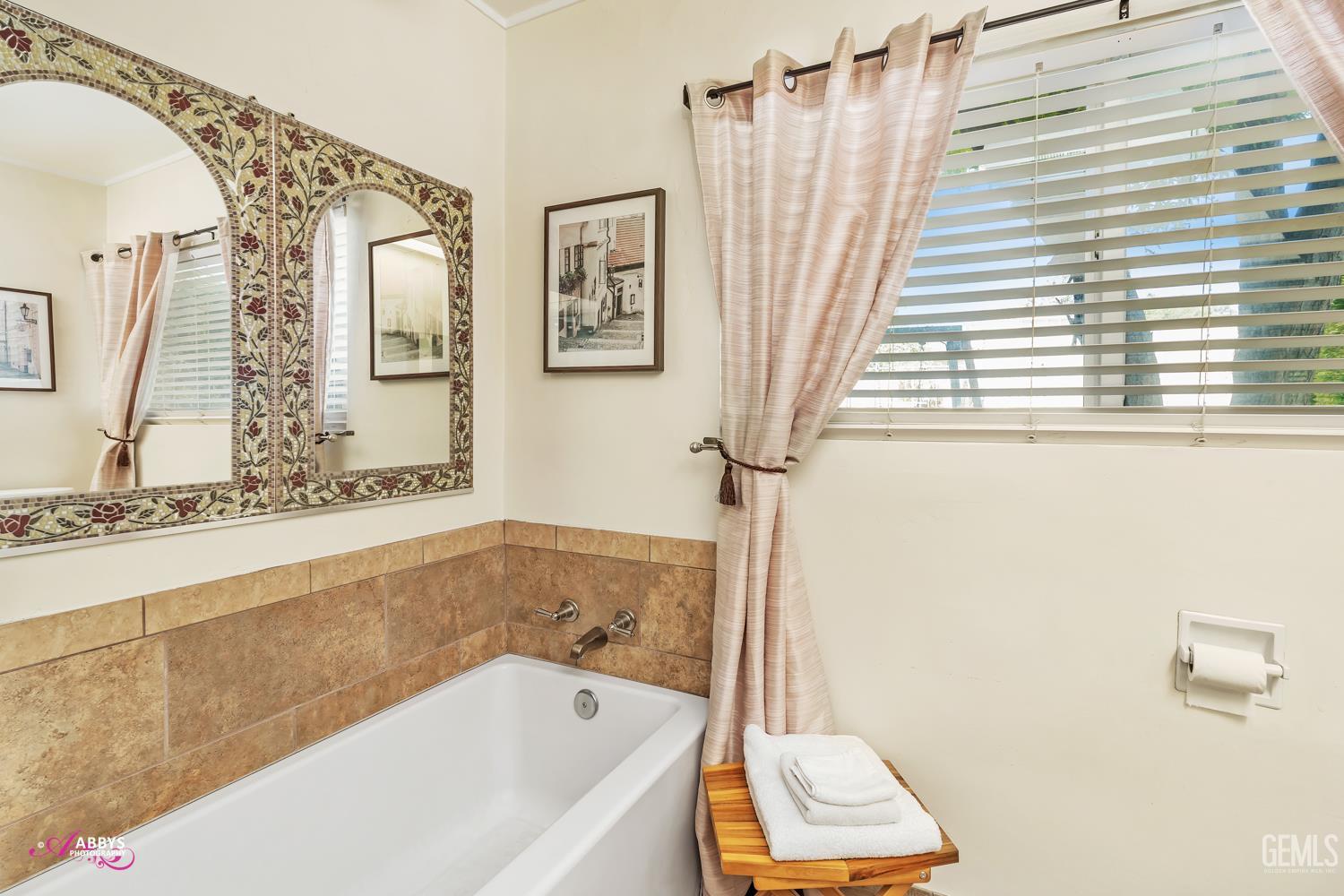 Undisclosed Address Bakersfield, CA 93306 - Photo 31 of 56 a bathroom with a bathtub a window and a shower