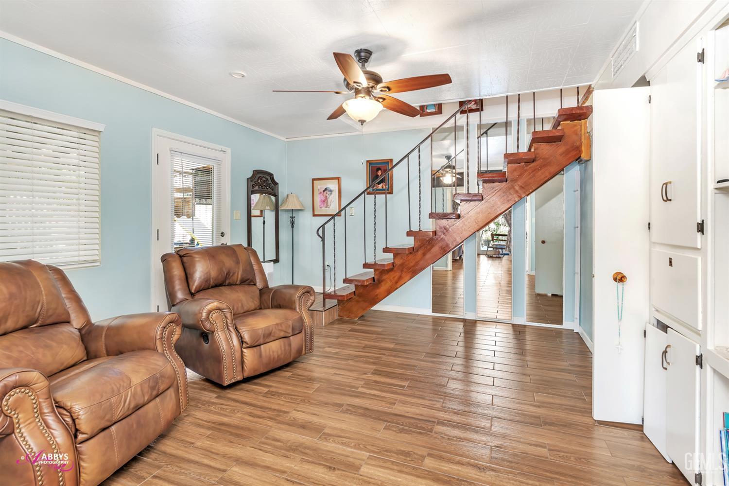 Undisclosed Address Bakersfield, CA 93306 - Photo 33 of 56 a living room with furniture and wooden floor