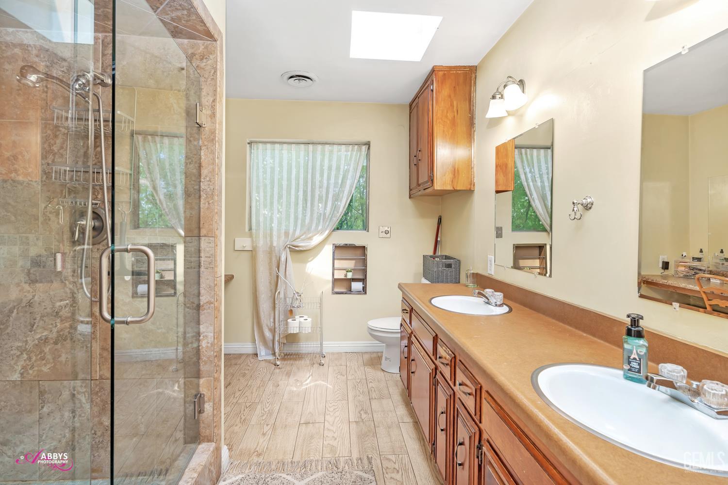 Undisclosed Address Bakersfield, CA 93306 - Photo 37 of 56 a spacious bathroom with a sink double vanity and a mirror