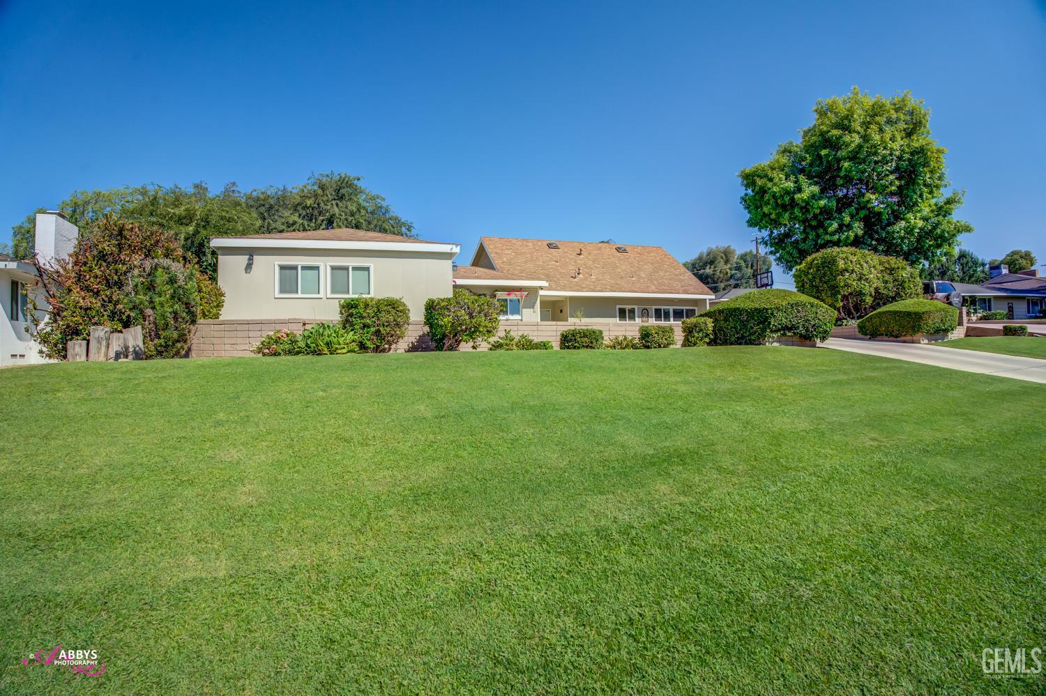 Undisclosed Address Bakersfield, CA 93306 - Photo 7 of 56 a front view of a house with a yard
