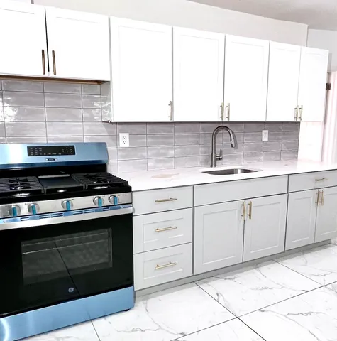 a kitchen with cabinets appliances and a sink