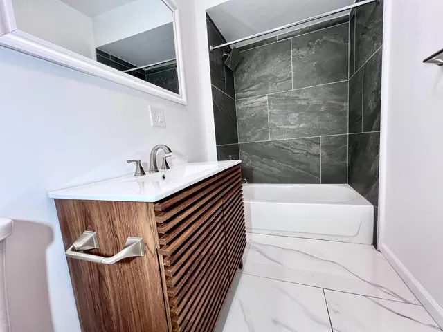 a bathroom with a sink a toilet a shower and bathtub