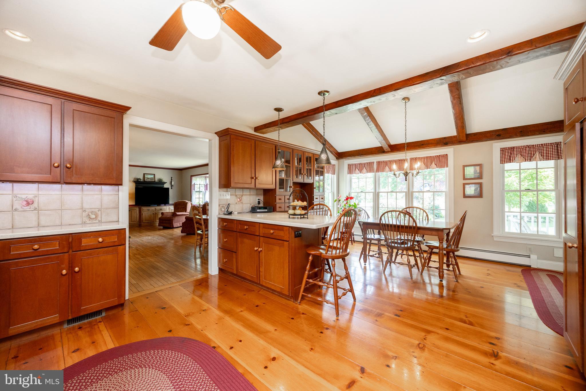 741 Cowpath Road Telford, PA 18969 - Photo 12 of 72 a dining hall with stainless steel appliances granite countertop a stove a sink a dining table and chairs with wooden floor